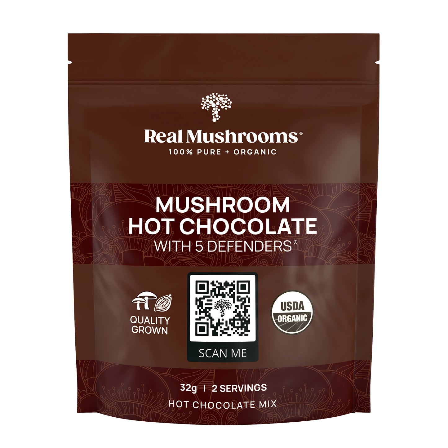 A brown package of Real Mushrooms Hot Chocolate Sample highlights the "5 Defenders" with organic mushroom extract, featuring the USDA Certified Organic logo and a handy QR code for more information.