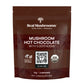 A brown package of Real Mushrooms Hot Chocolate Sample highlights the "5 Defenders" with organic mushroom extract, featuring the USDA Certified Organic logo and a handy QR code for more information.