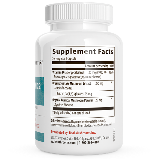 A white bottle of Real Mushrooms' Vitamin D from Organic Mushrooms displays its Supplement Facts label, listing Vitamin D2, organic shiitake extract, and organic Agaricus mushroom powder.