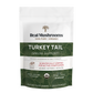 A white and green package with text on it for Real Mushrooms' Turkey Tail Mushroom Extract Powder for Pets.