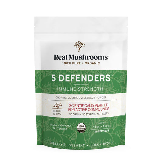 A package of Real Mushrooms 5 Defenders® Organic Mushroom Complex – Bulk Powder, an immune-supporting mushroom extract with beta-glucans, features certifications and product details on the front.