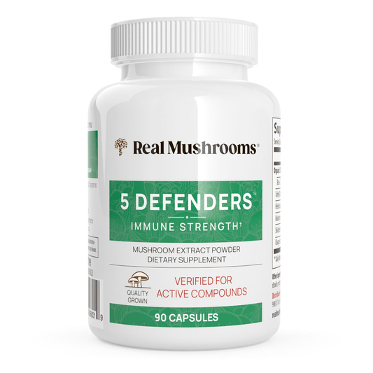 A white bottle labeled "Real Mushrooms 5 Defenders® Organic Mushroom Blend Capsules" contains 90 capsules of mushroom complex extract powder dietary supplement for immune support.