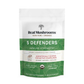 A white and green bag labeled "Real Mushrooms 5 Defenders® Organic Mushroom Complex – Bulk Powder" highlights immune support, beta-glucans, and various certifications on the front.