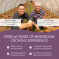 Two men smiling inside a greenhouse, likely father and son, with text highlighting their experience and expertise in Real Mushrooms Organic Chaga Extract Powder cultivation for over 40 years.