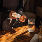 A person pours Organic Tremella Extract Capsules from a Real Mushrooms bottle into their hand, tapping into the wellness benefits of organic mushrooms. A glass of water rests on a wooden table nearby, bathed in warm sunlight.